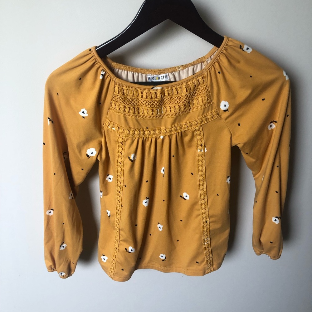 Long sleeved shirt with crocheted detail on the front.